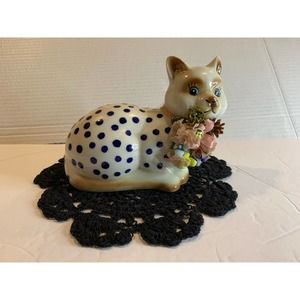 6” porcelain kitty cat laying on crochet rug doily